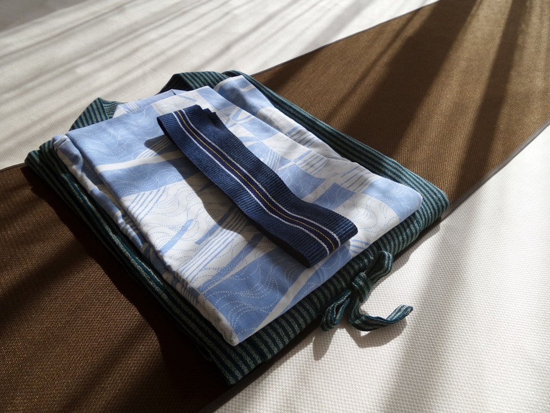 Travel laundry and wet-item bags separated beside a suitcase