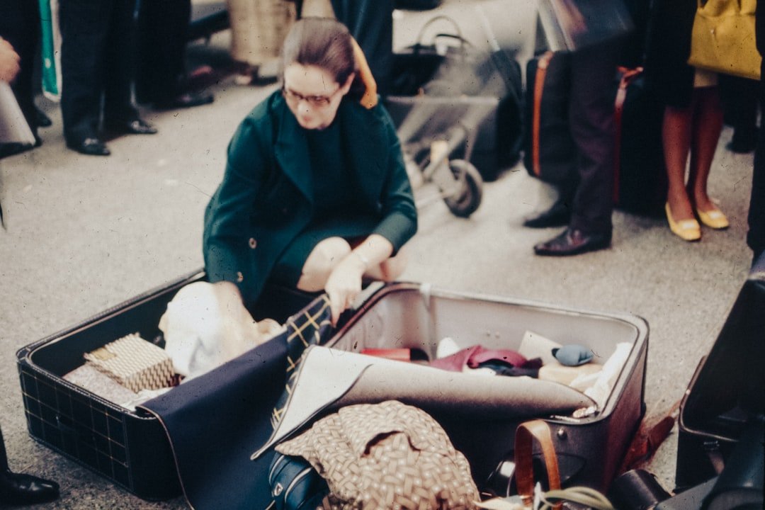 Traveler unpacking a suitcase and sorting laundry at home